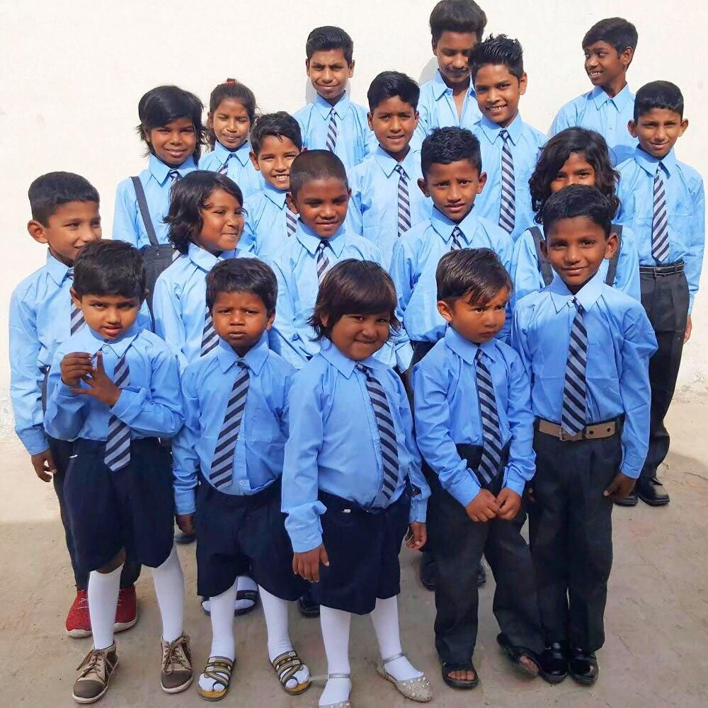 Smiling BrightColoursOrphanage children in blue school uniforms